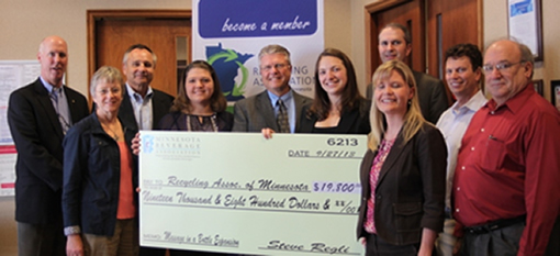 Members of the Minnesota Beverage Association present a check to the Recycling Association of Minnesota to purchase recycling bins for their Message in a Bottle program for away-from-home recycling.